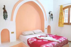 Postel nebo postele na pokoji v ubytování Hotel Sheherazade Luxor
