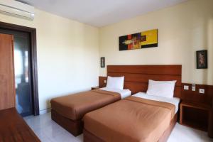Postel nebo postele na pokoji v ubytování Kondra Premiere Guest House Kuta