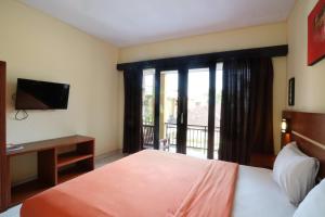 Postel nebo postele na pokoji v ubytování Kondra Premiere Guest House Kuta