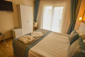 Postel nebo postele na pokoji v ubytování ParionHouse Hotel