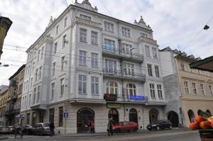 a large white building on the corner of a street at Hostel Tara in Kraków