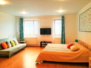 a bedroom with a bed and a couch at Apartment Promenada in Poděbrady