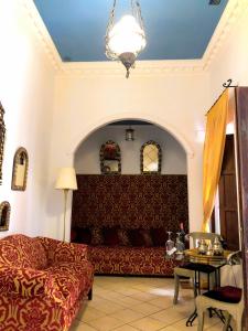 a living room filled with furniture and a large window at Hotel Casa Imperial in Seville