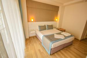 Postel nebo postele na pokoji v ubytování ParionHouse Hotel