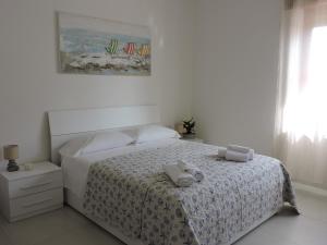 a bedroom with a bed with two towels on it at La casa del Moro in Sabaudia