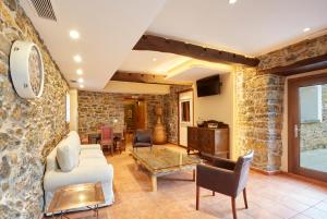 a living room with a stone wall at Casa Josefa in Murias