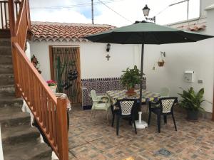 a patio with a table and an umbrella at La Trinidad in La Guancha