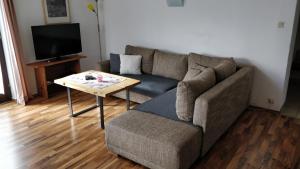 a living room with a couch and a coffee table at Haus Senn in Seefeld in Tirol