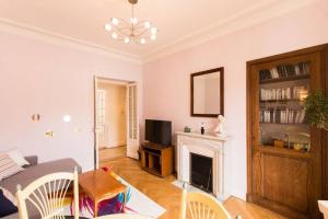 a living room with a fireplace and a television at Appartement carre d'or in Nice