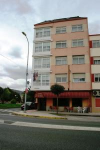 a large building with a large window on the side of the street at Hotel Kensington in Narón