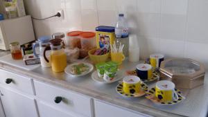 a counter with cups and plates of food on it at Tagus Host - 40308AL- 44211AL in Santarém