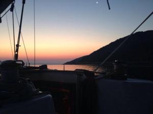 a boat in the water with the sunset in the background at Buena Vis-ta Apartments with the Sea View in Vis