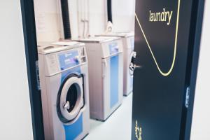 a laundry room with a washer and dryer at Ülemiste Airport Hostel in Tallinn