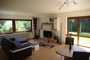 a living room with a couch and a table at Haus Panoramaweg in Sohren