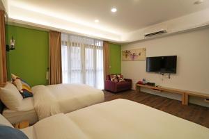 TV a/nebo společenská místnost v ubytování Penghu Little Apple B&B