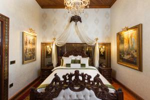 a bedroom with a large bed with a chandelier at Hotel 1207 Special Class in Antalya
