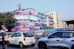 a group of cars parked in front of a building at Bothra Guest House in Kolkata
