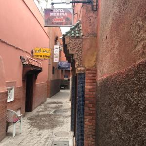 a narrow alley with a gate in a building at Hotel Medina in Marrakesh