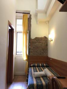 a bedroom with a bed and a window at Hotel Bolognese in Rome