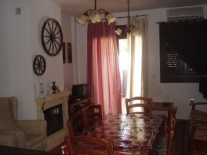 Ocio Aventura Rural في Los Romeros: غرفة طعام مع طاولة ومدفأة