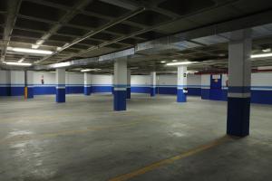 an empty parking garage with blue and white columns at Porcel Ganivet in Madrid