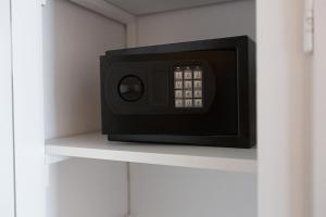a microwave on a shelf in a room at Flisvos Rooms in Livanates