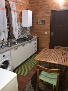 a kitchen with a table and a sink and a stove at Chalet Impero in Scauri