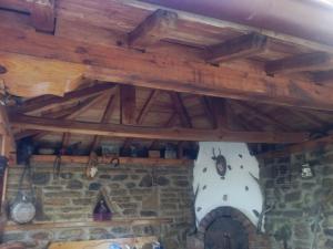 um tecto de madeira num quarto com uma lareira de pedra em Guest House Polah Ot Minaloto em Zheravna
