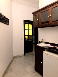 a bathroom with a sink and a black door at Hotel Casa Imperial in Seville