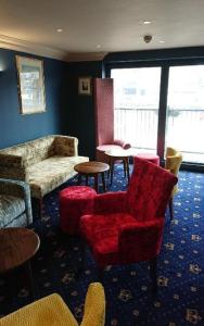 a red chair sitting in the middle of a room at The Queens Hotel in York