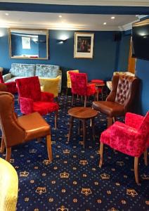 
a living room filled with furniture and a red carpet at The Queens Hotel in York
