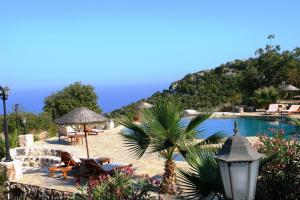 a resort with a pool and chairs and a mountain at Hoyran Wedre Country Houses in Davazlar