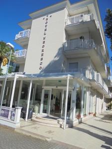 a large white building with windows and balconies at Hotel Negresco in Riccione