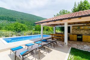 a house with a swimming pool and a gazebo at Beautiful Countryside Villa in Gruda