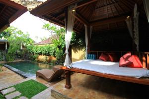 1 dormitorio con cama y piscina en Private Villa Wayan, en Ubud