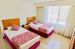 Postel nebo postele na pokoji v ubytování Portal del Rodeo ApartaHotel