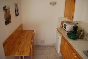 a small kitchen with a counter and a microwave at Gite Loisirs Provence in Annot