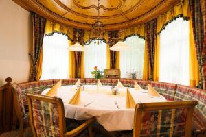 a large table in a room with yellow curtains at Sattelbogener Hof in Traitsching