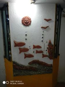 a wall with a painting of fish on it at Taura Comfort in Bangalore