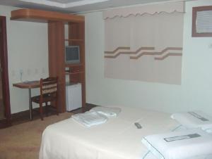 A bed or beds in a room at Hotel Gramado de Campos