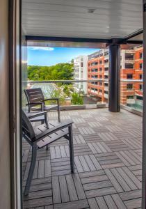 a balcony with two benches and a view of a city at Hotel Ithaca in Ithaca