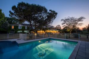 a swimming pool in front of a house at Le Renaissance in Mont-de-Marsan