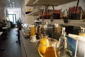 a counter with glasses of orange juice on it at La Pergola d'Arcachon in Arcachon