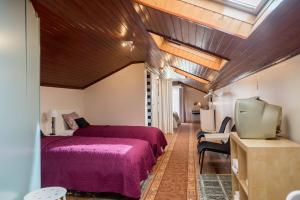 Un dormitorio con una cama y un televisor. en Lisbon Belém Guesthouse, en Lisboa