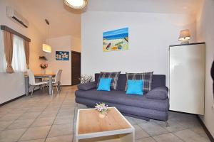 a living room with a couch and a table at Mare Medulin in Medulin