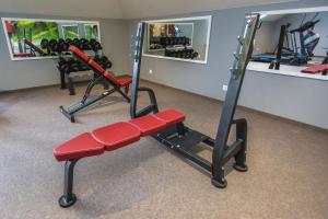 a gym with two exercise bikes and a red bench at Hotel nad Rabą - Bochnia in Bochnia