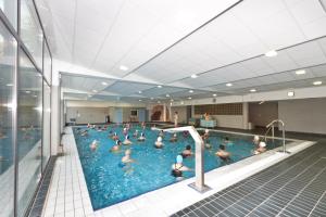 a group of people in a swimming pool at Villa Thermae Thonon-Les-Bains in Thonon-les-Bains