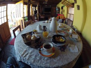a table with a plate of food and coffee on it at Loma Sanchez in San Pedro de Atacama