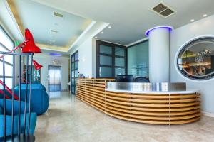 a lobby with a reception desk in a building at Porto Marine Hotel in Platamonas