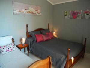 a bedroom with two beds and two candles in it at Maison Oxalys in Bastia